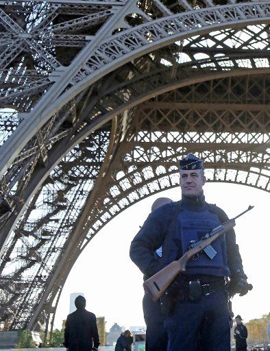 Police patrol the Eiffel Tower in Paris on November 15, 2015. Major monuments remain closed and security enhanced two days after the city was struck by a series of coordinated attacks that claimed at least 120 lives. The Islamic State (ISIS) has ...