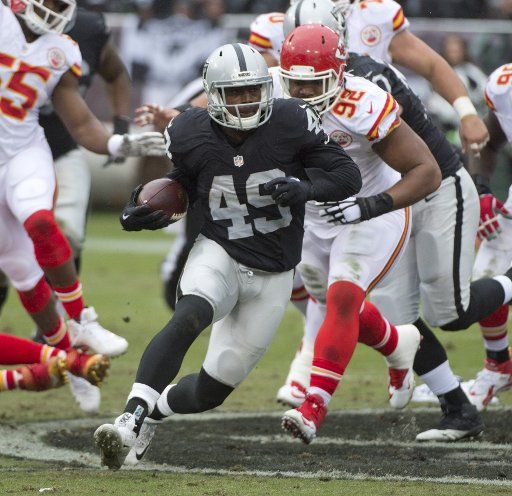 Oakland Raiders Jamize Olawale (49) runs against the Kansas City Chiefs in the second quarter at O.co Coliseum in Oakland, California on December 6, 2015. The Chiefs defeated the Raiders 34-20. Photo by Terry Schmitt\/
