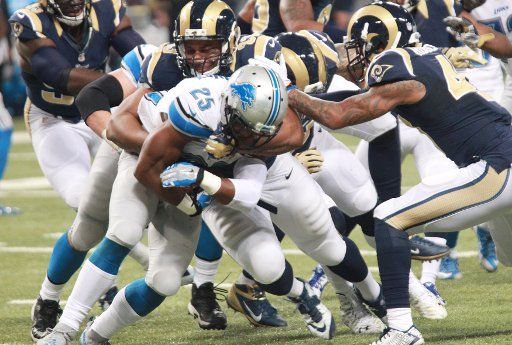 Detroit Lions Theo Riddick is stopped by the St. Louis Rams defense in the first quarter at the Edward Jones Dome in St. Louis on December 13, 2015. St. Louis defeated Detroit 21-14. Photo by Bill Greenblatt\/