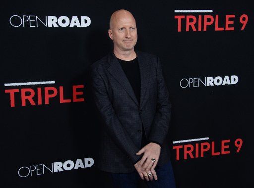Director John Hillcoat attends the premiere of the motion picture crime thriller "Triple 9" at Regal L.A. Live in Los Angeles on February 16, 2016. Storyline: A crew of dirty cops is blackmailed by the Russian mob to execute a virtually impossible ...