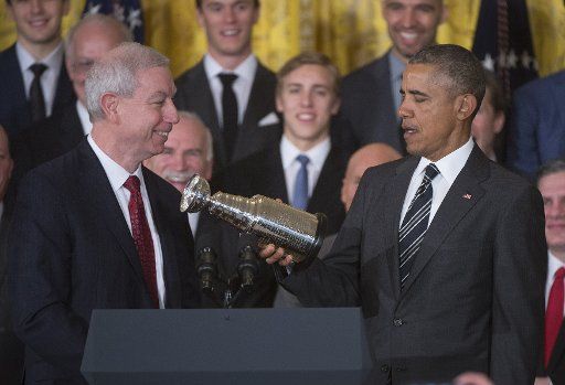 President Barack Obama receives a mini Stanley Cup from Chicago Blackhawks President and CEO John McDonough as Obama welcomes the 2015 NHL Champions Chicago Blackhawks to the White House in Washington, D.C. on February 18, 2016. Photo by Kevin ...