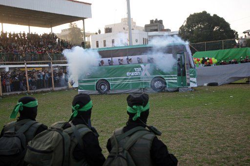 A mock Israeli bus is seen on fire during an anti-Israel rally organized by the Hamas movement in Rafah in the southern Gaza February 26, 2016. Photo by Ismael Mohamad\/