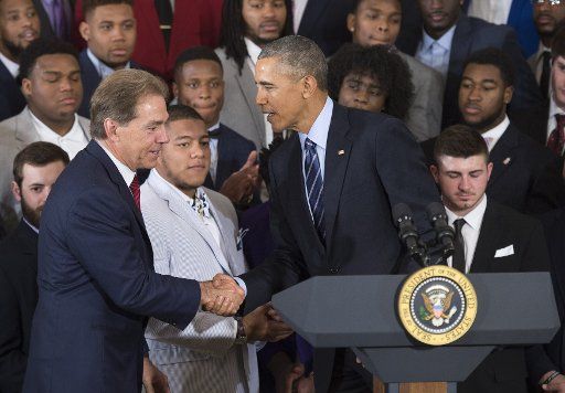 Nick Saban, head football coach of the University of Alabama, shakes hands with President Barack Obama during an event where Obama honored the 2015- 2016 College Football Playoff National Champion Alabama Crimson Tide, in the East Room at the White ...