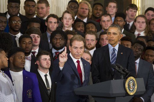 U.S. President Barack Obama (right) looks on while Alabama Head Coach Nick Saban (left) offers remarks during a ceremony to honor the 2015- 2016 College Football Playoff National Champion Alabama Crimson Tide in the East Room at The White House in ...