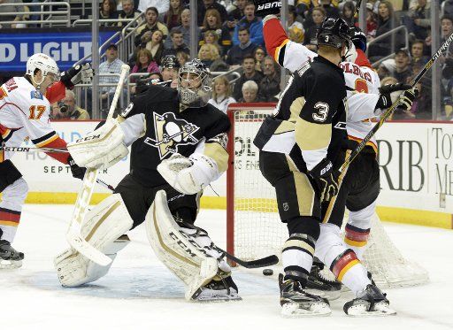 Pittsburgh Penguins goalie Marc-Andre Fleury (29) reacts as Calgary Flames center Joe Colborne (8) scores in the first period at the Consol Energy Center in Pittsburgh on March 5, 2016. Photo by Archie Carpenter\/