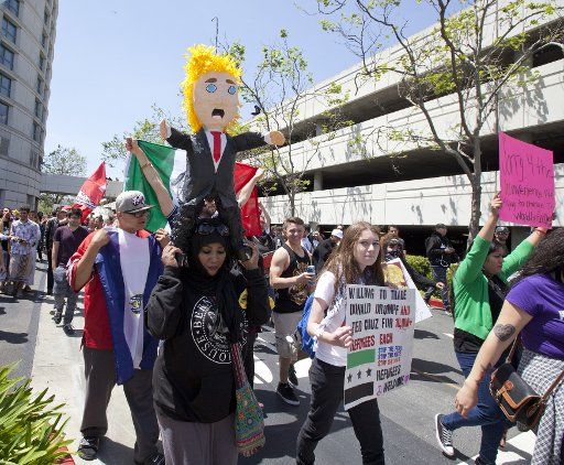 Protesters against Republican candidate Donald Trump march on the grounds of the Hyatt Regency at the California GOP convention in Burlingame, California on April 29, 2016. Trump was the keynote speaker at the party\