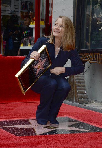 Actress Jodie Foster holds a replica plaque during an unveiling ceremony honoring her with the 2,580th star on the Hollywood Walk of Fame in Los Angeles on May 4, 2016. Photo by Jim Ruymen\/