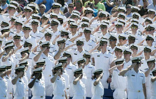 Underclass Midshipmen salute during the 2016 Graduation and Commissioning Ceremony at the U.S. Naval Academy in Annapolis, Maryland on May 27, 2016. Photo by Kevin Dietsch\/