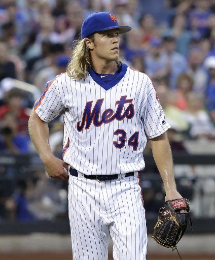 New York Mets starting pitcher Noah Syndergaard walks to the dugout after the first inning against the Los Angeles Dodgers at Citi Field in New York City on May 28, 2016. Photo by John Angelillo\/