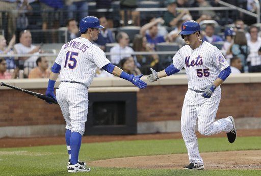 New York Mets Kelly Johnson celebrates with Matt Reynolds after hits a solo home run in the 3rd inning against the Pittsburgh Pirates at Citi Field in New York City on June 15, 2016. Photo by John Angelillo\/