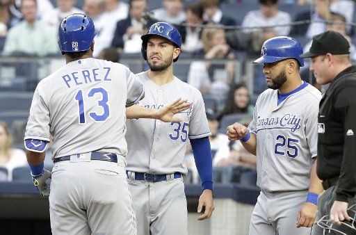 Kansas City Royals Salvador Perez celebrates with Kendrys Morales and Eric Hosmer after he hits a 3-run home run in the first inning against the New York Yankees at Yankee Stadium in New York City on May 11, 2016. Photo by John Angelillo\/
