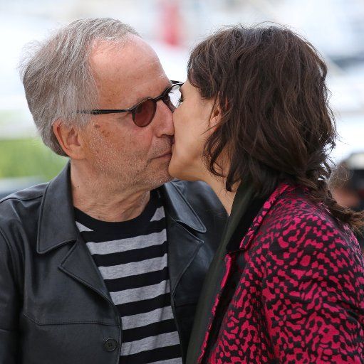 Fabrice Luchini and Juliette Binoche share a kiss at a photocall for the film "Ma Loute (Slack Bay)" during the 69th annual Cannes International Film Festival in Cannes, France on May 13, 2016. Photo by David Silpa\/