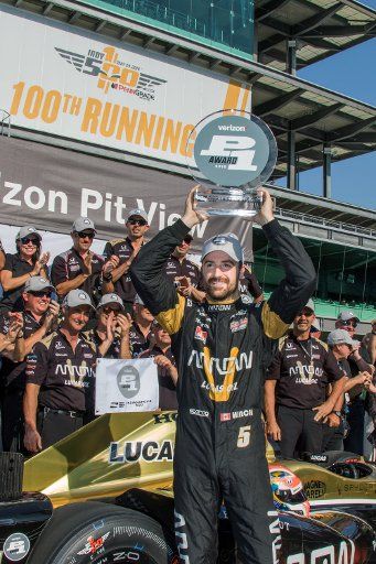 James Hinchcliffe hoists the pole award trophy after winning the pole during Pole Day Shoot out qualifications for the 100th running of the Indianapolis 500 at the Indianapolis Motor Speedway on May 22, 2016 in Indianapolis, Indiana. Photo by Ed ...