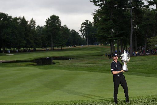 Jimmy Walker holds the Wanamaker Trophy after the final round at the PGA Championship at Baltusrol Golf Club in Springfield, New Jersey on July 31, 2016. Walker won the championship and his first major with a score of 14 under par. Photo by ...