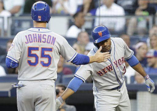 New York Mets Kelly Johnson celebrates at home plate with Curtis Granderson after scoring a run in the 2nd inning against the New York Yankees at Yankee Stadium in New York City on August 3, 2016. Photo by John Angelillo\/
