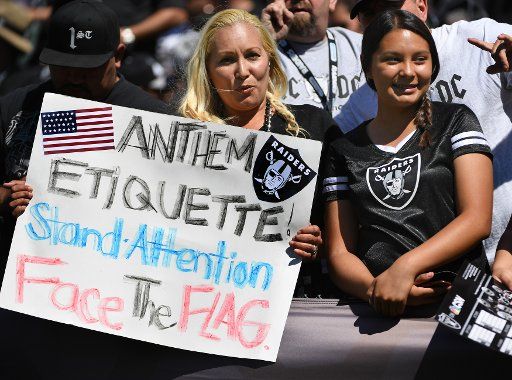 An Oakland Raiders fan weighs in on the National Anthem controversy at the Coliseum in Oakland, California on September 18, 2016. The Atlanta Falcons defeated the Oakland Raiders 35-28. Photo by Terry Schmitt\/