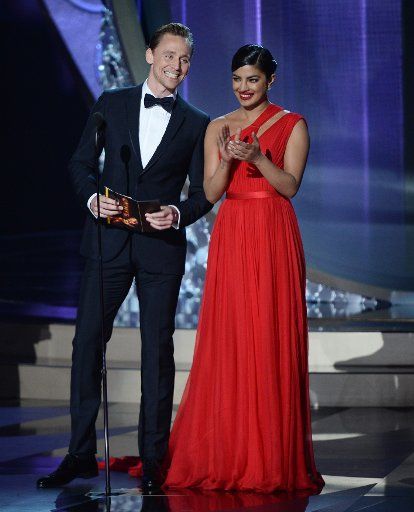 Actors Tom Hiddleston and Priyanka Chopra (R) speak onstage during the 68th Annual Primetime Emmy Awards at Microsoft Theater in Los Angeles on September 18, 2016. Photo by Jim Ruymen\/