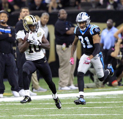 New Orleans Saints wide receiver Brandin Cooks (10) takes a Drew Brees pass for 87 yards and a touchdown in the first quarter at the Mercedes-Benz Superdome in New Orleans October 16, 2016. Defending on the play is Carolina Panthers cornerback Zack ...