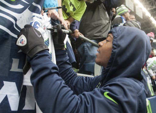 Seattle Seahawks wide receiver Tyler Lockett signs autographs before their game against the Atlanta Falcons at CenturyLink Field in Seattle, Washington on October 16, 2016. Photo by Jim Bryant\/
