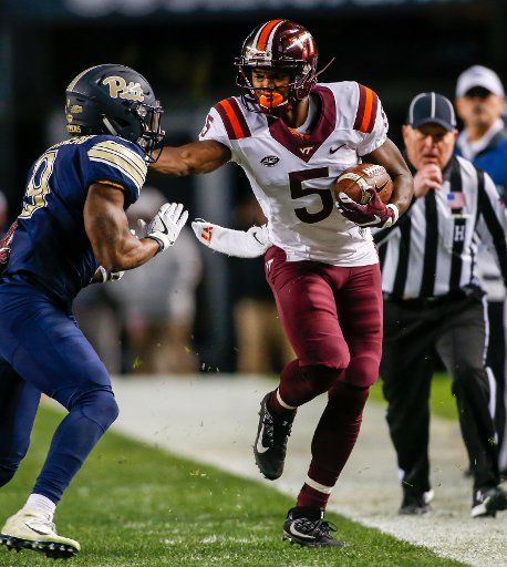 Virginia Tech Hokies wide receiver Cam Phillips (5) stiff arms Pittsburgh Panthers defensive back Jordan Whitehead (9) in the first quarter in Pittsburgh on October 27, 2016. Photo by Matt Durisko\/