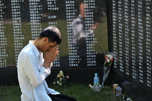 Worshippers pray for victims in front of the monument "Cornerstone of Peace" of Battle of Okinawa at the Peace memorial park in Itoman, Okinawa, Japan, on June 23, 2016. Photo by Keizo Mori\/