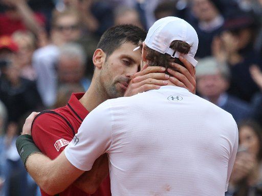 Novak Djokovic (L) of Serbia meets Andy Murray of the United Kingdom at the net after their French Open men\