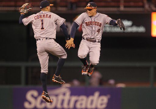 Houston Astros outfielders Carlos Correa and George Springer jump high after the third out and a 5-2 win over the St. Louis Cardinals at Busch Stadium in St. Louis on June 14, 2016. Photo by Bill Greenblatt\/