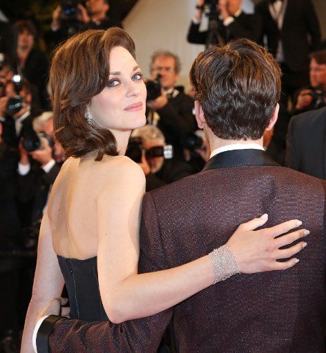 Marion Cotillard and Xavier Dolan arrive on the red carpet before the screening of the film "Juste la fin du monde (It\