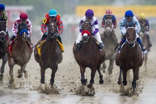 Kentucky Derby winner Nyquist, center, runs down the opening stretch with the rest of the field at the 141st running of the Preakness Stakes at Pimlico Race Course on May 21, 2016 in Baltimore, Maryland. Exaggerator, ridden by jockey, Kent ...