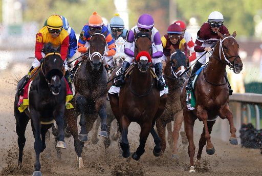 Jockey Mario Gutierrez with Nyquist (C) leads the pack coming down the front stretch of the 142nd running of Kentucky Derby May 7, 2016, at Churchill Downs in Louisville, Kentucky. Photo by John Sommers II\/