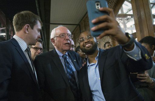Democratic presidential candidate Sen. Bernie Sanders (I-VT) takes a selfie photo with attendees at the James Clyburn Fish Fry in Charleston, South Carolina, on January 17, 2106. Photo by Kevin Dietsch\/