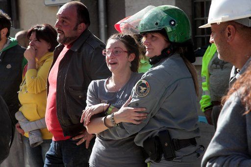 Italians cry of the victims during rescuers search for victims wounded in Amatrice, Italy, after a 6.2-magnitude earthquake struck the region killing more than 240 people on August 24, 2016. Workers continue to search for victims as aftershocks hit ...