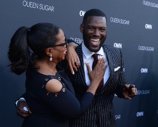 Executive producer Oprah Winfrey (L) and cast member Kofi Siriboe attend the premiere of OWN\