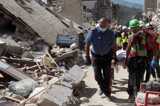 Rescuers carry the bodies of victims in Amatrice, Italy, after a 6.2-magnitude earthquake struck the region killing more than 240 people on August 24, 2016. Workers continue to search for victims as aftershocks hit the area on August 25, 2016. Photo ...