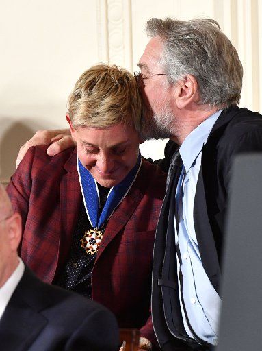 Actor Robert De Nero hugs comedian Ellen DeGeneres after President Barack Obama awarded her the Presidential Medal of Freedom, during a ceremony at the White House in Washington, DC, on November 22, 2016. Obama awarded 21 medals to distinguished ...
