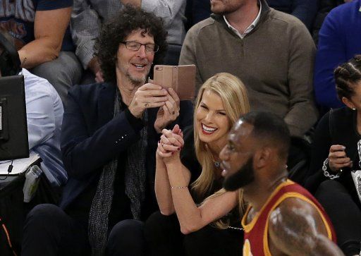 Howard Stern and Beth Ostrosky take a photo of Cleveland Cavaliers LeBron James on the court in the game against the New York Knicks at Madison Square Garden in New York City on December 7, 2016. The Cavaliers defeated the Knicks 126 to 94. ...