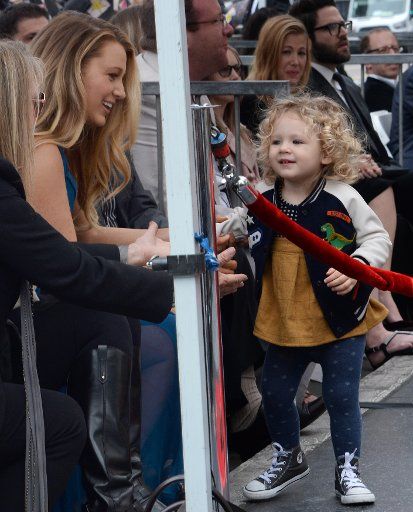 Actress Blake Lively and her daughter James are all smiles during an unveiling ceremony honoring her husband, actor Reynolds with the 2,596th star on the Hollywood Walk of fame in Los Angeles on December 15, 2016. Photo by Jim Ruymen\/