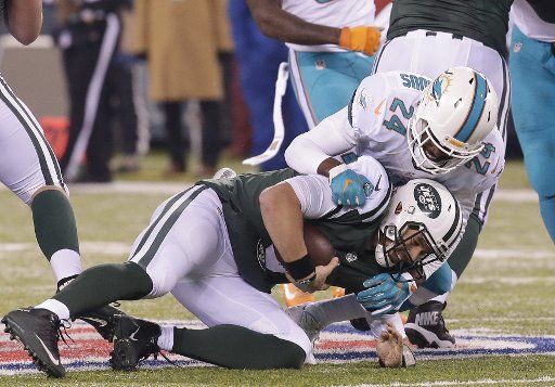New York Jets Bryce Petty is sacked for a 3 yard loss by Miami Dolphins Isa Abdul- Quddus in week 15 of the NFL at MetLife Stadium in East Rutherford, New Jersey on December 17, 2016. Photo by John Angelillo\/