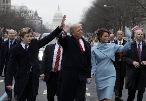 President Donald Trump and First Lady Melania Trump walk with son Barron,10, during the inaugural parade after the inauguration in Washington, D. C. on January 20, 2017. Pool photo\/