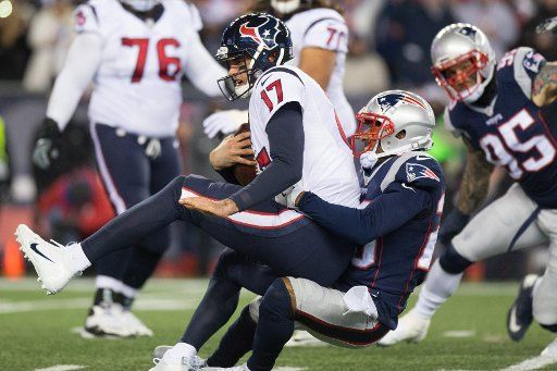 Houston Texans quarterback Brock Osweiller (17) is sacked by New England Patriots cornerback Logan Ryan (26) in the first quarter against the New England Patriots in AFC Divisional game at Gillette Stadium in Foxborough, Massachusetts on January 14, ...