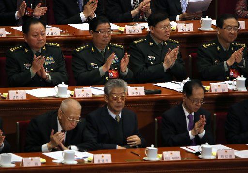 Chinese military delegates applaud during the opening of the fifth session of the 12th National People\