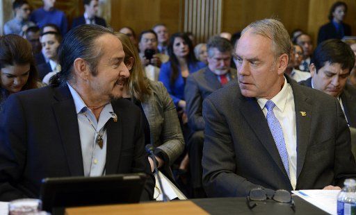 Interior Secretary Ryan Zinke (R) chats with Keith Anderson, vice chairman of the Shakopee Mdewakanton Sioux Community of Minnesota, prior to Senate Indian Affairs Committee hearings, March 8, 2017, in Washington, DC. The panel addressed the issue ...