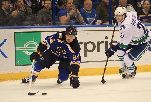 St. Louis Blues Nail Yakupov of Russia goes down in front of Vancouver Canucks Ben Hutton in the first period at the Scottrade Center in St. Louis on February 16, 2017. Photo by BIll Greenblatt\/