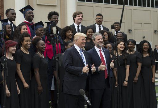 President Donald Trump poses with Liberty University President Jerry Falwell and the LU Praise gospel choir after delivering the commencement speech at Liberty University in Lynchburg, Virginia, May 13, 2017. Photo by Molly Riley\/