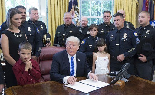 U.S. President Donald J. Trump signs a proclamation supporting police officers at The White House in Washington, DC, May 15, 2017. Photo by Chris Kleponis\/