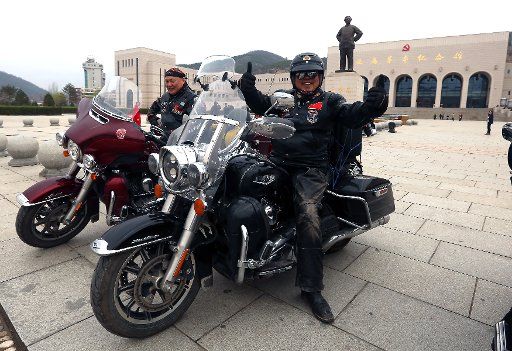 Chinese bikers arrive on the square of the Revolution Museum, featuring a giant bust of former helmsman Mao Zedong, on their Harley-Davidson\