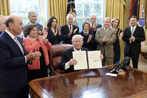 U.S President Donald Trump signs a Memorandum on Aluminum Imports and Threats to National Security in the Oval Office of the White House in Washington, DC, on April 27, 2017. Photo by Olivier Douliery\/
