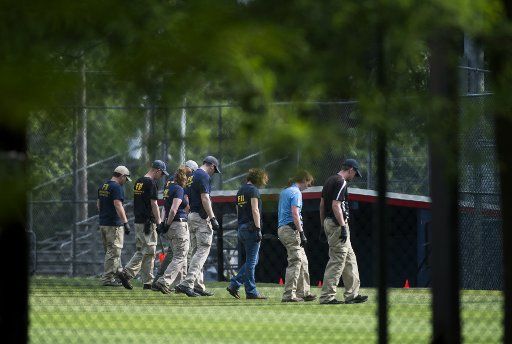 FBI Evidence Response Team search for evidence on Simpson Field where a gunman opened fire during a GOP baseball practice, in Alexandria, Virginia, June 14, 2017. House Majority Whip Steve Scalise and at least three others were shot during the ...