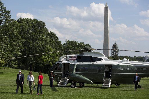 President Donald Trump, First Lady Melania Trump and their son, Barron Trump, cross the South Lawn after arriving at the White House on June 18, 2017 in Washington, D.C. President Trump spent the weekend at Camp David. Photo by Zach Gibson\/