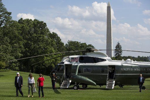President Donald Trump, First Lady Melania Trump and their son, Barron Trump, cross the South Lawn after arriving at the White House on June 18, 2017 in Washington, D.C. President Trump spent the weekend at Camp David. Photo by Zach Gibson\/